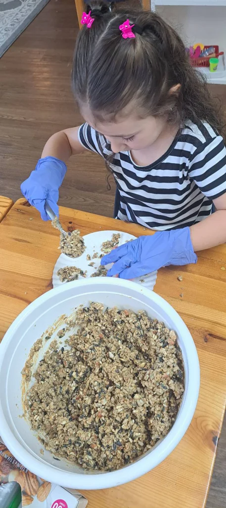 Child wearing gloves while preparing a classroom food activity