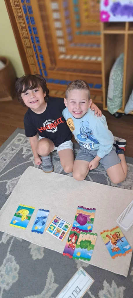 Two students working together with picture matching cards on a classroom rug