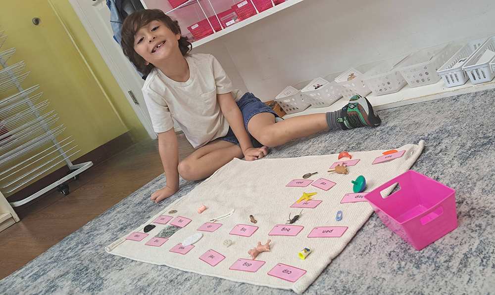 Child matching small objects to word labels during a Montessori language activity