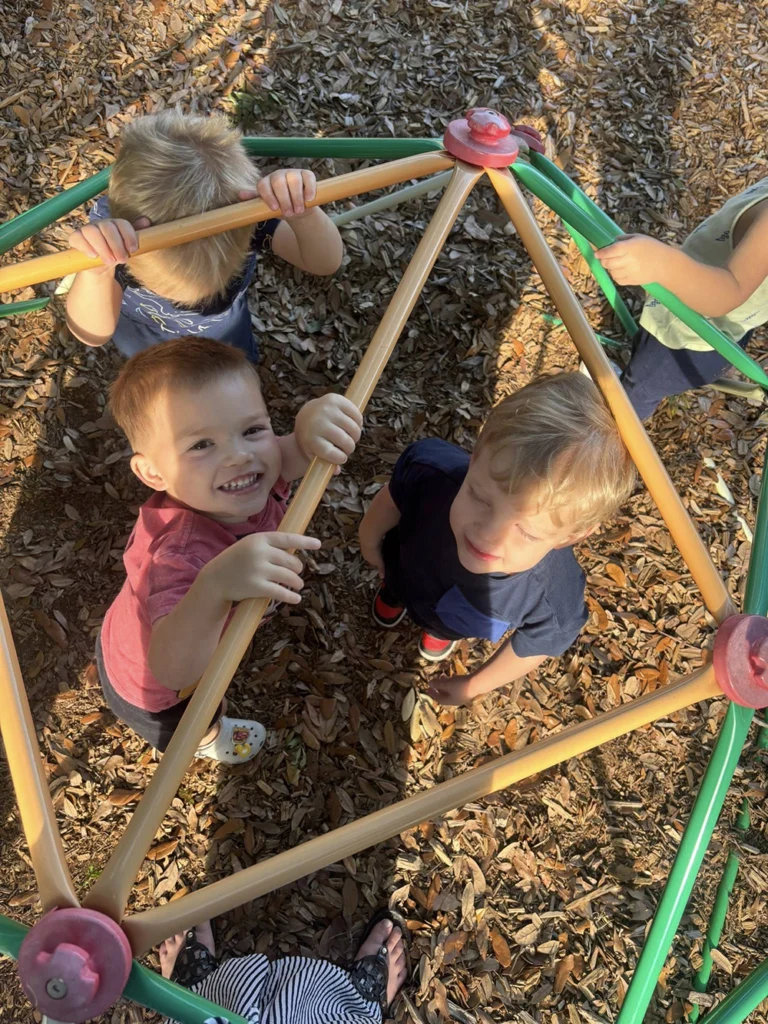Children climbing on outdoor playground equipment