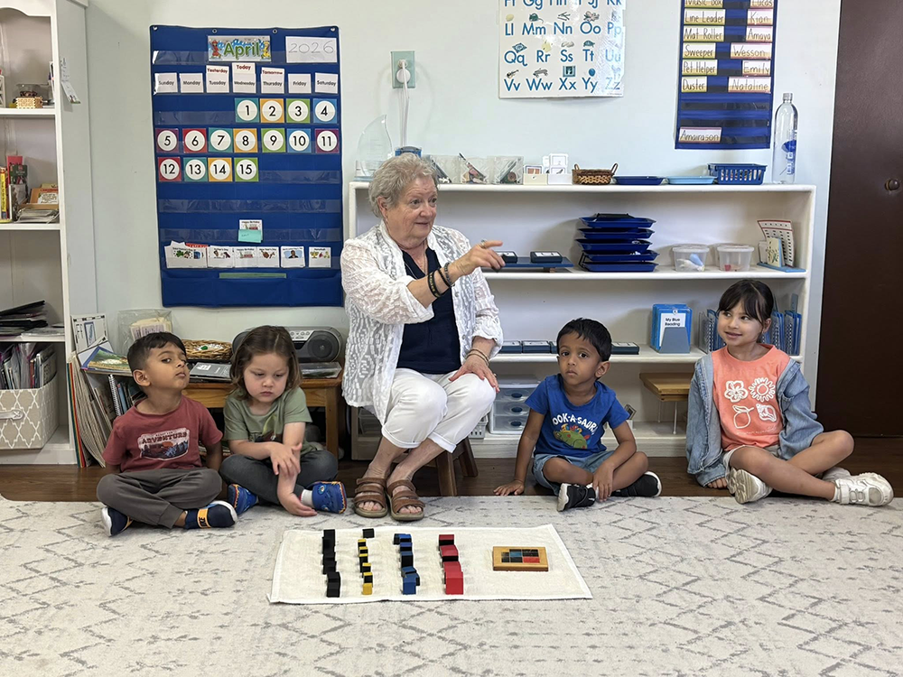 Teacher guiding young students during a Montessori group lesson