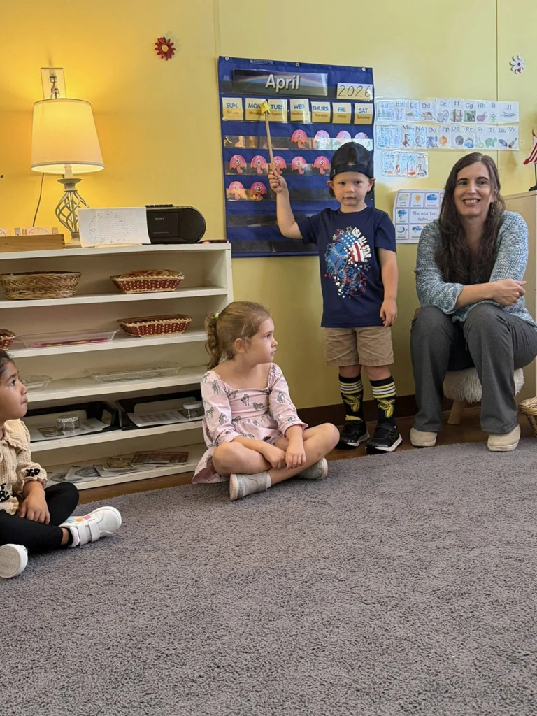 Teacher leading students during calendar time in a Montessori classroom