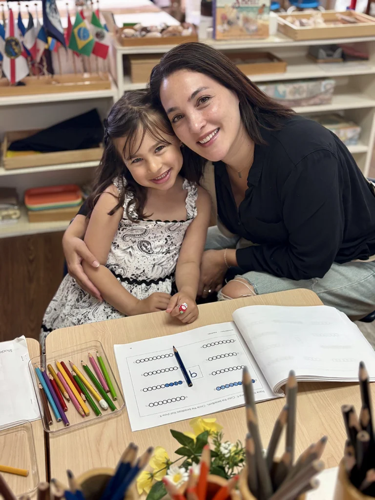 Montessori student doing a writing activity with mom