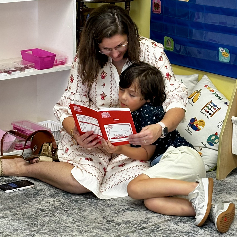 Mom and her son sitting closely together as she reads to him